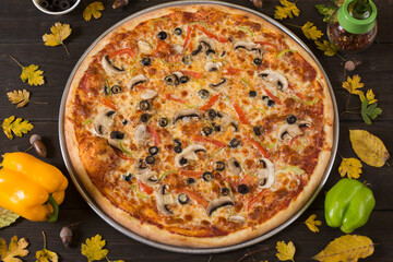 Fresh just made pizza with vegetables, spices for pizza in restaurant.
