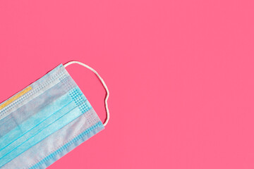 Closeup medical face mask on pink background