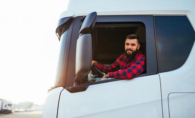 Young handsome bearded man driving his truck.
