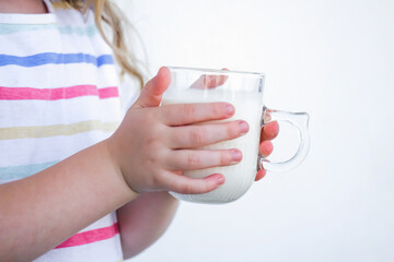 child holding a glass of milk