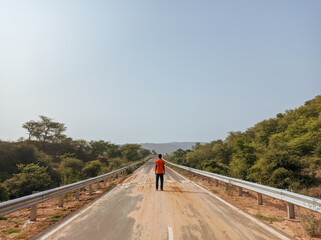 man on the road that middle of mountains