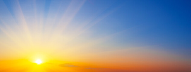 Naklejka na ściany i meble Panorama of dramatic sunset sky with sunbeams