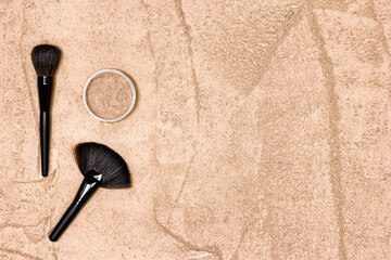 Make-up powder with makeup brushes. Loose face powder texture. Minimal concept with copy space....