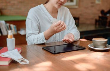 Asian businesswoman cleaning hand and computer before online woking. Social distancing and new...