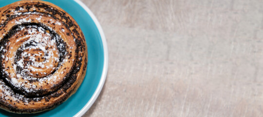 Poppy seed bun on wooden background. Place for text, copy space
