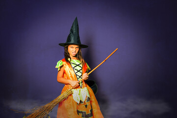 Obraz premium Halloween witch spooky girl portrait with broom over dark background