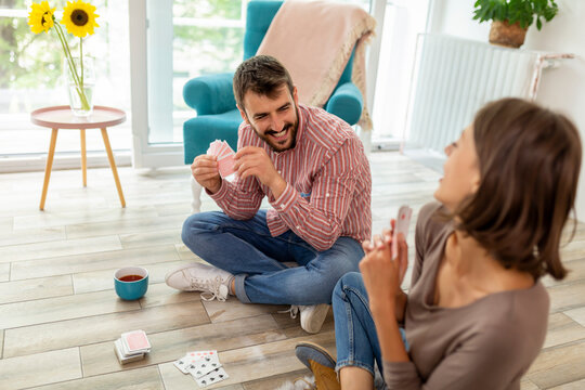 Couple playing cards at home