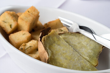Traditional back side dish of Madeira cuisine - sweet potato (batata) slices baked in the oven with herbs