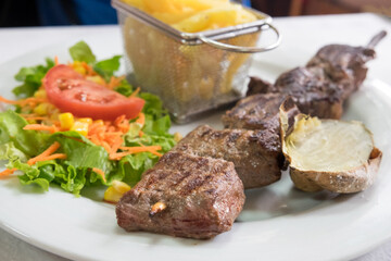 The traditional Madeira dish espetada or beef on a skewer, seasoned with salt, garlic and bay leaves, is roasted in a brazier and served directly from the skewer. 