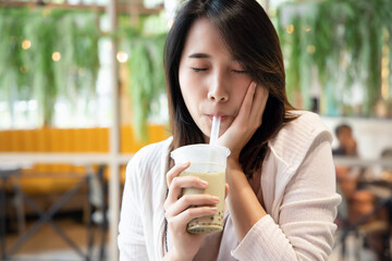 happy young asian woman drinking boba milk tea, bubble milk tea, pearl milk tea