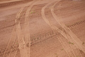 Tracks from car wheels on the wet sand after the rain, passed two cars