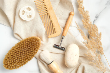 Flat lay composition with men's shaving tools and bath accessories on marble background.