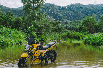 Motorbike in the middle of the river.