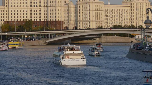 Time lapse Moskva river with cruise ships, near the Kotelnicheskaya Embankment Building and Zaryadye Park, Moscow, Russia.