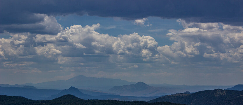 clouds over the mountains, Spooky Clouds over the Mountains, Ominous Clouds Over a Mountain Range, Storm Clouds over a Mountain Landscape