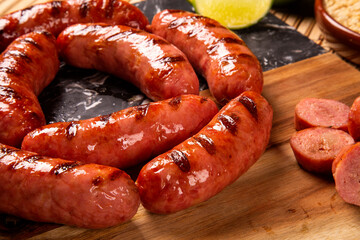 Grilled sausage. Grilled Sausage on wooden board. Brazilian barbecue.