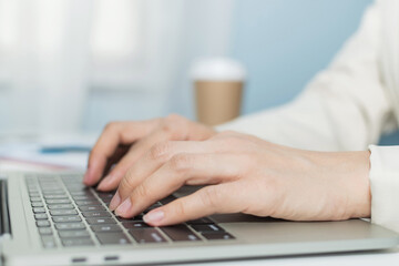 attractive businesswoman in white suit hand working about finance business on digital laptop computer on desk in meeting room at home office, digital online marketing and financial business concept