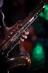 Fototapeta premium Men's hand holding a sax in dark background
