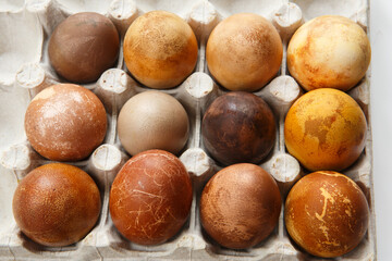 box of twelve original, unique colorful dragon or dinosaur looking like chicken Easter eggs, dyed with natural products (red wine, tea, coffee, carrots, turmeric, soy sauce)