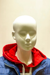 Closeup of a female mannequin face at a women's clothing shop.