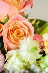 Flower arrangement with a sunflower in a basket on a black background. Stylish flowers for sale. Artistic style. Rustic style. Selective focus.