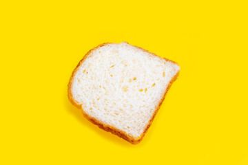 Fototapeta na wymiar Close up photo of fresh baked toast bread on yellow background. Top view. Bread for breakfast.
