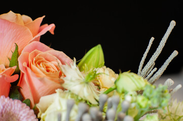 Flower arrangement with a sunflower on a black background. Macro photo. Stylish flowers for sale. Artistic style. Rustic style. Selective focus.