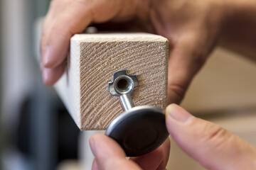 a Man is installing a adjustable screw