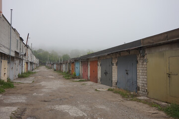 Fototapeta na wymiar A foggy morning in garages where people leave cars for the night. 