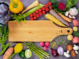 cutting board with vegetables and knife