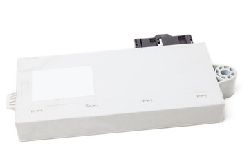 The plastic case of the car engine control unit on a white isolated background is the connecting...