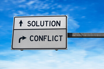 Solution versus conflict. White two street signs with arrow on metal pole. Directional road,...