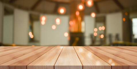 Empty wooden table top with lights bokeh on blur restaurant background	