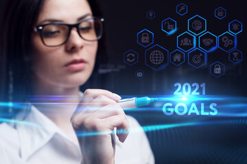 Business, Technology, Internet and network concept. Young businessman working on a virtual screen of the future and sees the inscription: 2021 goals