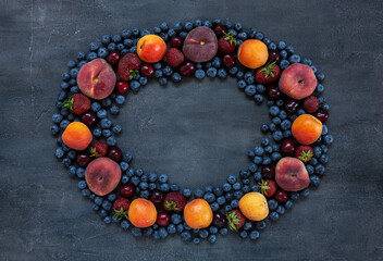 Fresh juicy berries and fruits, wreath pattern, close-up, top view