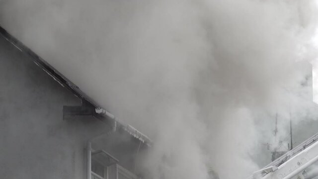 Fire fighter on ladder engulfed in smoke house fire Reykjavik Iceland