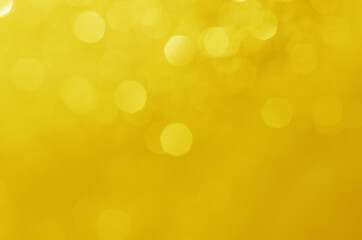 abstract defocused yellow bokeh sparkling light glitter background. for wallpaper backdrop and template.