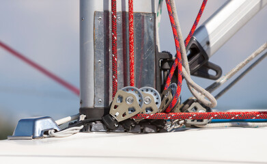 Pulley and rope system at the base of the mast for  sail installing on board the yacht