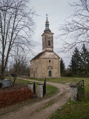 Naklejka premium An old abandoned church building in a dilapidated condition against a gloomy sky during the cloudy day.