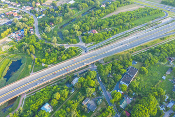 Aerial view of car driving through the forest on country road