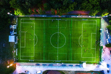Aerial view on football stadium illuminated by jupiter on evening.