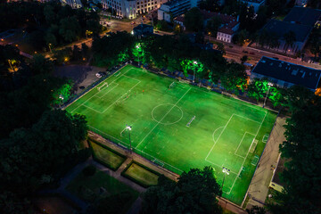 Plakat Aerial view on football stadium illuminated by jupiter on evening.