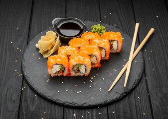 Philadelphia roll with fresh fish on black background