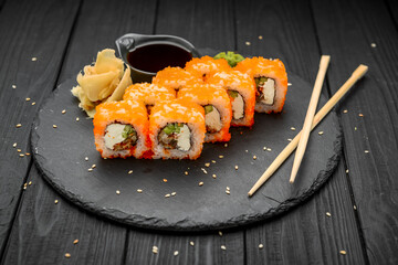 Philadelphia roll with fresh fish on black background