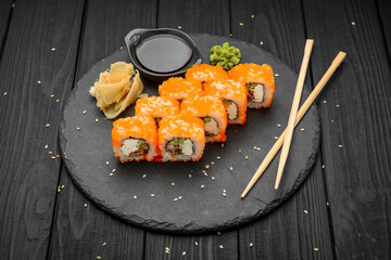 Philadelphia roll with fresh fish on black background