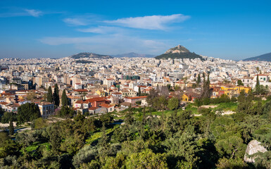 Fototapeta na wymiar Panoramic view of metropolitan Athens, Greece with Lycabettus Lycabettus hill and Pedion tou Areos park seen from Areopagus rock