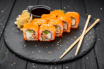 Philadelphia roll with fresh fish on black background