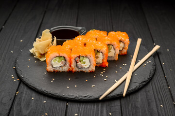 Philadelphia roll with fresh fish on black background