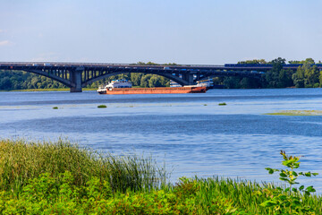 Heavy long barge sailing on the Dnieper river in Kiev, Ukraine