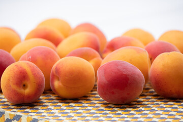 Ripe apricots on a beige tray